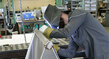 Technician constructing a machine component.